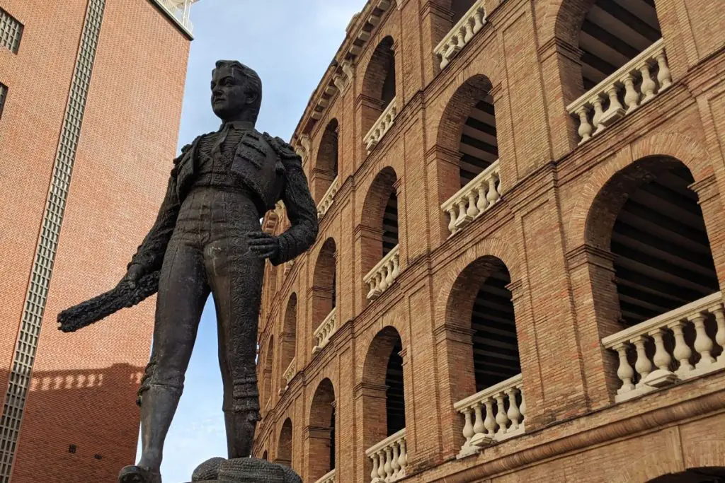 Outside the bullring in Valencia with a statue of a famous bullfighter