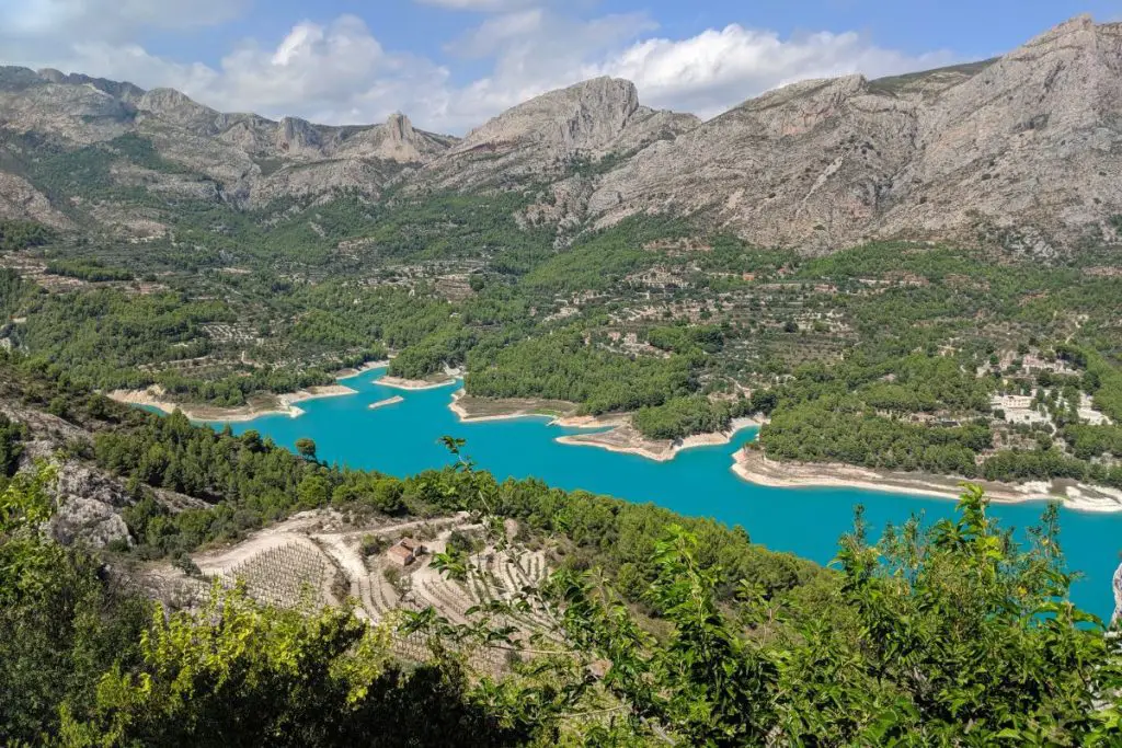The beautiful bright blue reservoir surrounded by mountains at Guadalest