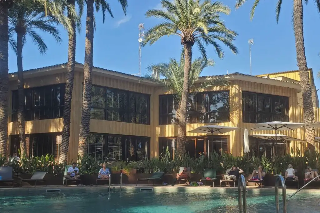 Hotel Huerto del Cura Elche pool A view of the Hotel Huerto del Cura and people sunbathing around the pool