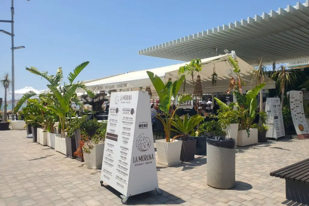 santa pola la moruna La Moruna Restaurant in Santa Pola, with a menu board and banaa plants outside