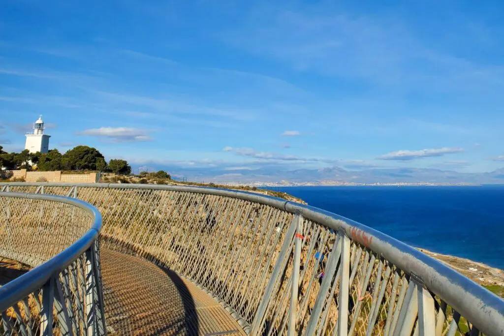 santa pola lighthouse The skywalk in Santa Pola with the sea to the right and the white lighthouse in the distance